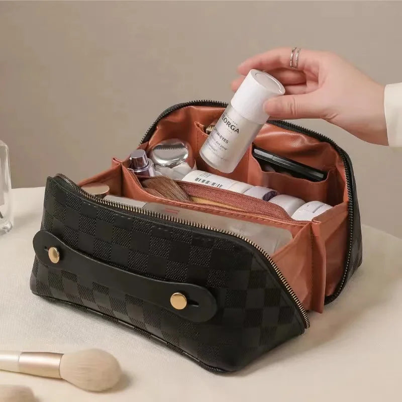 Black toiletry bag for women, Fancy material and look, Metal zipper, Top view, Handle, Women's' hand using it, Opened toiletry bag, Filled with quality makeup, Bag sitting on table, Lifestyle image