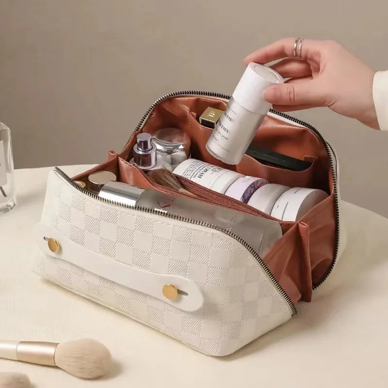 White toiletry bag for women, Fancy material and look, Metal zipper, Top view, Handle, Women's' hand using it, Opened toiletry bag, Filled with quality makeup, Bag sitting on table, Lifestyle image